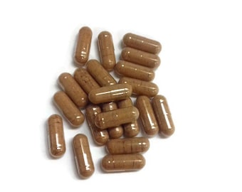 May include: A pile of brown capsules on a white background.