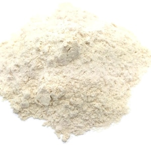 May include: A close-up of a pile of white, fine-textured, wheat flour.