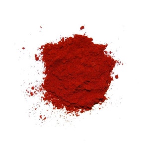 May include: A pile of bright red paprika powder, a common spice used in cooking.