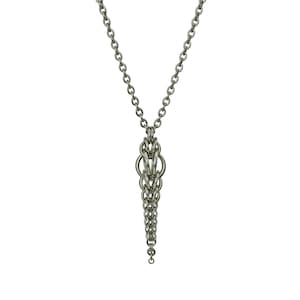 May include: A silver chain necklace with a long, intricate pendant made of linked metal rings.