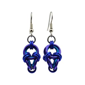 May include: A pair of dangle earrings with a blue and purple colour gradient. The earrings are made of metal and have a simple, elegant design.