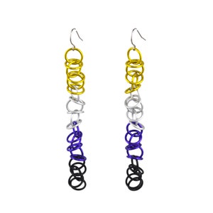 May include: A pair of long dangle earrings with multiple rings in black, purple, silver, and gold colors.