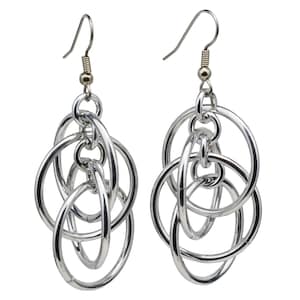 May include: Silver dangle earrings with multiple interlocking circles.