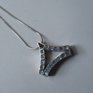Silver pendant with light blue topazs