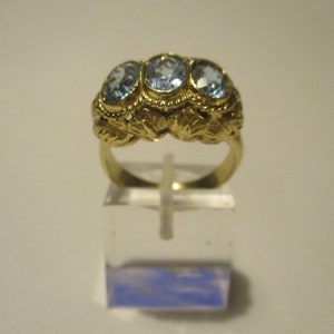 Old fashion style ring with light blue topaz