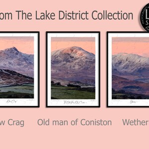 May include: Three framed photographs of mountain landscapes in the Lake District, England. The photos show snow-capped peaks, rolling hills, and a clear sky with a pink hue. The photos are titled "Dow Crag", "Old man of Coniston", and "Wetherlam".