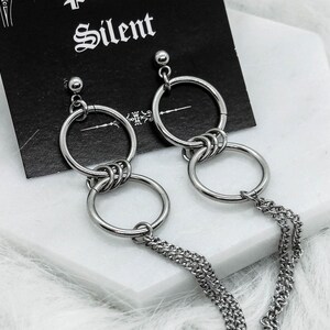 May include: A white ceramic mug with a black handle and the text "But First, Coffee" in a handwritten style. The mug is on a white surface. The mug is likely for hot beverages.