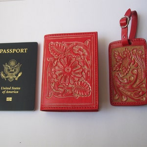May include: Red leather passport holder and luggage tag set with a floral embossed design. The passport holder has the words "PASSPORT" and "United States of America" printed on the front.