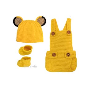May include: A yellow crochet baby outfit set, including a hat with bear ears, a pair of booties, and a romper with wooden buttons. The set is made of soft yarn and is designed for newborns.
