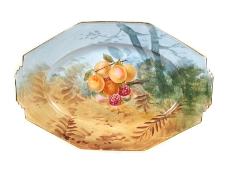 May include: Octagonal porcelain serving platter with a blue and gold rim. The platter features a hand-painted scene of a tree branch with fruit and berries.