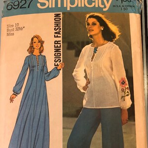 May include: Simplicity sewing pattern number 6927, Designer Fashion, for a long dress and pants. The dress is blue and the pants are blue with a white blouse. The pattern includes a transfer for embroidery.