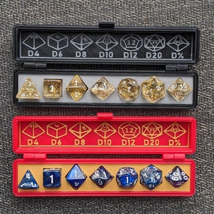 May include: A set of seven polyhedral dice in a red and black carrying case. The dice are numbered 4, 6, 8, 10, 12, 20, and a percentage die. The dice are made of clear plastic with gold flecks and blue swirls. The case has a label on the top that says "D4 D6 D8 D10 D12 D20 D%".