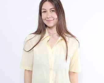 Blusa amarilla de poliéster de los 90: Top vintage de manga corta con hombreras, talla M.