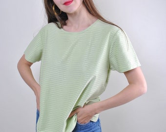 May include: A light green striped t-shirt with short sleeves. The shirt has a round neckline and is made of a soft, textured fabric.
