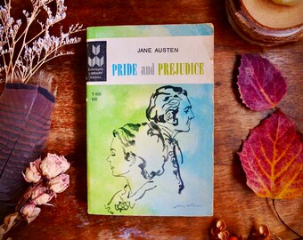 May include: A vintage paperback copy of Jane Austen's "Pride and Prejudice" with a green and blue watercolor illustration of a couple on the cover. The book is part of the Scholastic Library Edition.