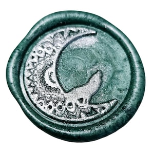 May include: A green wax seal with a silver crescent moon and intricate design. The moon has a wolf silhouette inside.