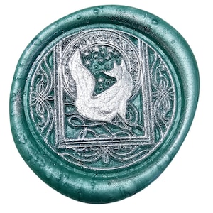May include: A green wax seal with a silver design of a bird in a square frame.