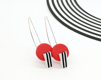 Red geometric earrings with black and white stripes