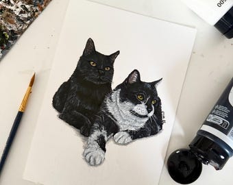 May include: A painting on white paper featuring two cats lying down. One cat is solid black with yellow eyes, and the other is black and white with yellow eyes. The artwork is surrounded by a paintbrush, a paint palette, and tubes of acrylic paint.