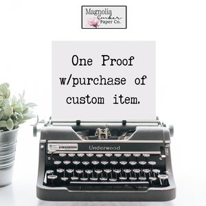 May include: A vintage typewriter with a white sheet of paper inserted. The paper has the text "One Proof w/purchase of custom item." printed on it. The typewriter is black and has the word "Underwood" printed on it.