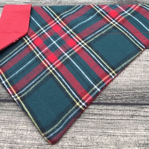 May include: A green and red plaid dog bandana with a red felt backing.