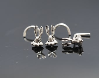 May include: Three silver nose rings with a rabbit head design. The rabbit heads are facing forward with their ears pointing up.