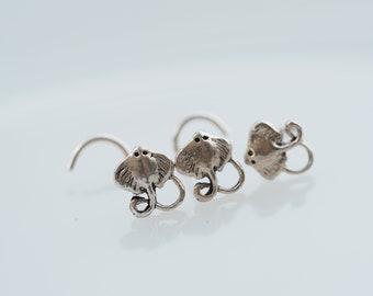 May include: A pair of silver earrings featuring a stingray design. The earrings are made of metal and have a hook closure.