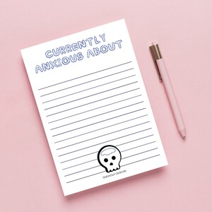 May include: A white printable notepad with blue lines and the text "CURRENTLY ANXIOUS ABOUT" at the top. A skull with a brain cloud is at the bottom with the text "SHEWOLF DESIGNS".