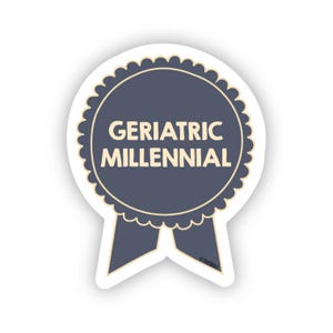 May include: A blue and cream colored sticker with a ribbon design. The sticker says "Geriatric Millennial".