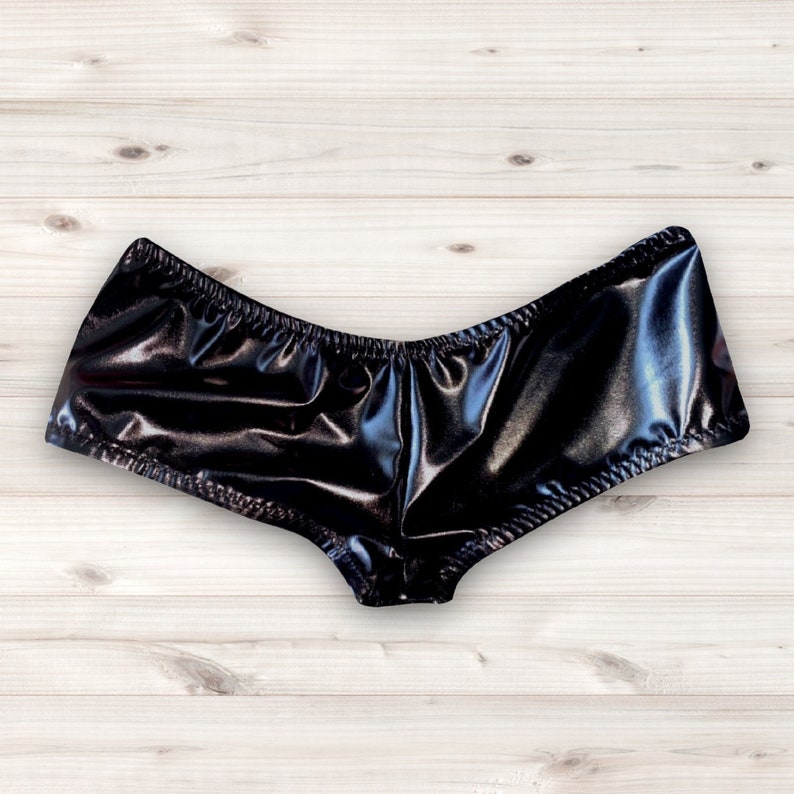 May include: Black shiny shorts with a gathered waistband.
