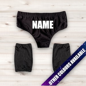 May include: Black underwear with the word "NAME" printed in white. Two black leg warmers are also included. The text "OTHER COLORS AVAILABLE" is printed on a diagonal across the bottom of the image.