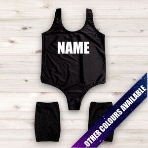 May include: Black swimsuit with the word "NAME" printed in white on the front. The swimsuit has a scoop neck and a racerback style. Two black leg warmers are included.