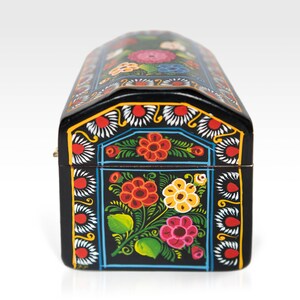 May include: A black, arched-top wooden box with a hinged lid. The box is adorned with a vibrant floral design in red, orange, yellow, and pink, set against a black background. The edges are decorated with white and yellow accents.