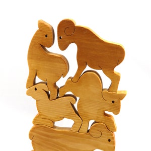 Handmade wooden toy stacking puzzle with five freestanding goats finished with a custom blend of nontoxic oils and waxes.