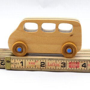 Handmade wood toy minivan made by me in my shop using traditional woodworking tools. It is hand finished with clear shellac with metallic sapphire blue acrylic paint.
