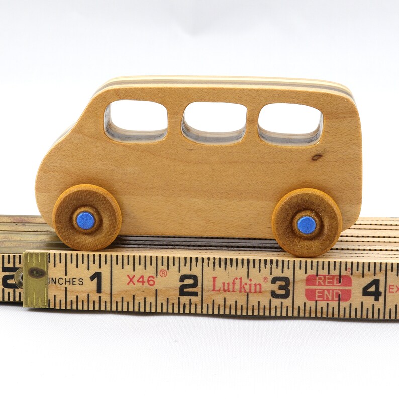 Handmade wood toy minivan made by me in my shop using traditional woodworking tools. It is hand finished with clear shellac with metallic sapphire blue acrylic paint.
