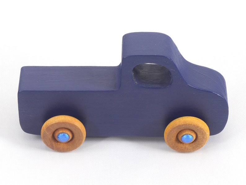 Handmade wooden toy pickup truck handmade and painted navy blue with amber shellac wheels and metallic sapphire blue trim. It's a little blue truck from my Play Pal Collection.