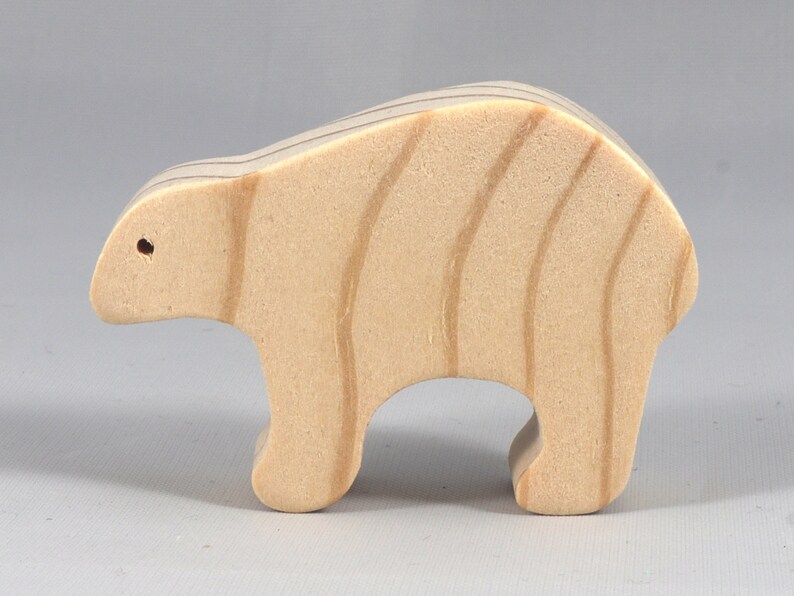 This is an unfinished wooden bear cutout from solid wood using traditional woodworking techniques. Sanded smooth and ready to paint, stain, or customize. Freestanding design for small hands, toddlers, young children, crafters, collectors, and display. I take custom orders for any animal, quantity, and mix — including large ornament orders. Mix and match, request a different size, or send a drawing or pattern. Handmade by Odin's Toy Factory in Tallahassee, Florida, USA.