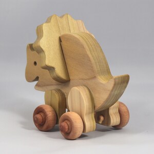 Handmade wooden push toy Triceratops dinosaur made from select grade hardwoods and finished with a non-toxic coating.