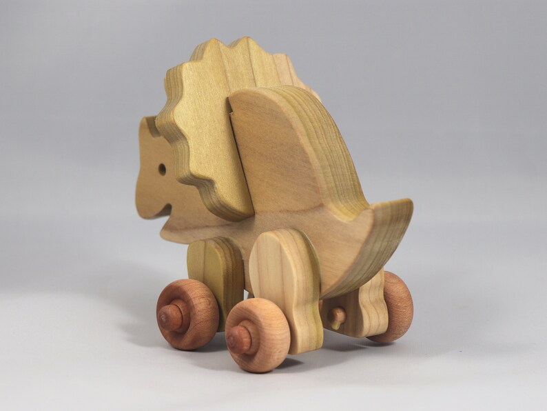 Handmade wooden push toy Triceratops dinosaur made from select grade hardwoods and finished with a non-toxic coating.