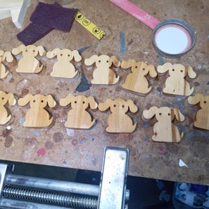 This is an unfinished wooden Puppy Dog cutout from solid wood using traditional woodworking techniques. Sanded smooth and ready to paint, stain, or customize. Freestanding design for small hands, toddlers, young children, crafters, collectors, and display. I take custom orders for any animal, quantity, and mix — including large ornament orders. Mix and match, request a different size, or send a drawing or pattern. Handmade by Odin's Toy Factory in Tallahassee, Florida, USA.