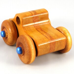 Wood Toy Monster Truck Handmade Form Hardwood and Finished With Amber Shellac With Metallic Saphire Blue Trim.