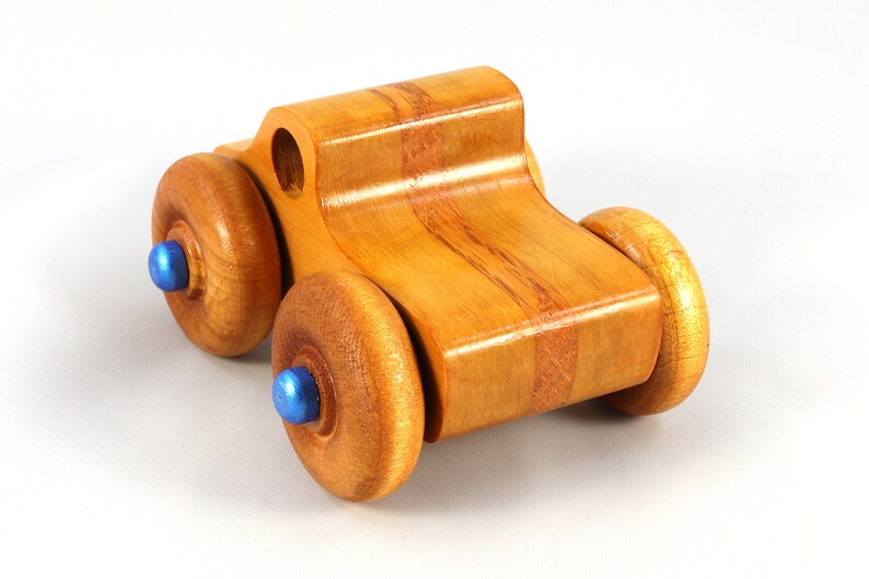 Wood Toy Monster Truck Handmade Form Hardwood and Finished With Amber Shellac With Metallic Saphire Blue Trim.