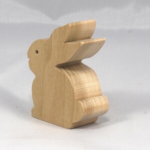 This is an unfinished wooden Rabbit cutout from solid wood using traditional woodworking techniques. Sanded smooth and ready to paint, stain, or customize. Freestanding design for small hands, toddlers, young children, crafters, collectors, and display. I take custom orders for any animal, quantity, and mix — including large ornament orders. Mix and match, request a different size, or send a drawing or pattern. Handmade by Odin's Toy Factory in Tallahassee, Florida, USA.