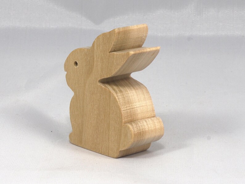 This is an unfinished wooden Rabbit cutout from solid wood using traditional woodworking techniques. Sanded smooth and ready to paint, stain, or customize. Freestanding design for small hands, toddlers, young children, crafters, collectors, and display. I take custom orders for any animal, quantity, and mix — including large ornament orders. Mix and match, request a different size, or send a drawing or pattern. Handmade by Odin's Toy Factory in Tallahassee, Florida, USA.