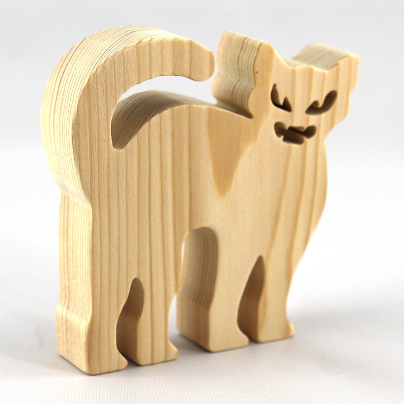 Handmade unfinished wooden Halloween cat cutout by Odin's Toy Factory. Freestanding cat figure cut from 3/4 inch thick wood and ready to paint. Approximate size 3.5 inches height by 3.5 inches width by 0.75 inches thick. Hand-cut solid wood Halloween decoration for crafts, toys, ornaments, and display. Custom orders available. Made in Tallahassee, Florida, USA.
