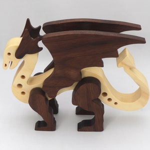 Handmade wooden dragon figurine made from contrasting hardwoods with a light natural wood body and head paired with rich dark reddish-brown wings, legs, and horns.
