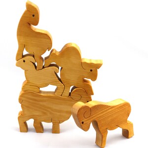 Handmade wooden toy stacking puzzle with five freestanding goats finished with a custom blend of nontoxic oils and waxes.