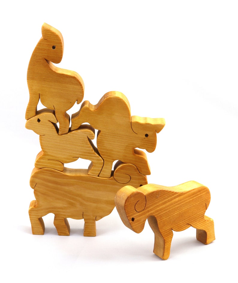 Handmade wooden toy stacking puzzle with five freestanding goats finished with a custom blend of nontoxic oils and waxes.