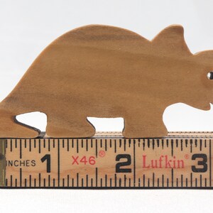 This small wooden triceratops dinosaur toy is crafted from high-quality hardwood and hand-finished. It is a delightful plaything for young children and appeals to many adults.